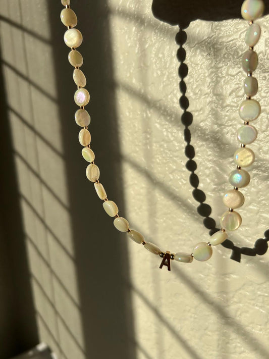 Flat pearl with letter